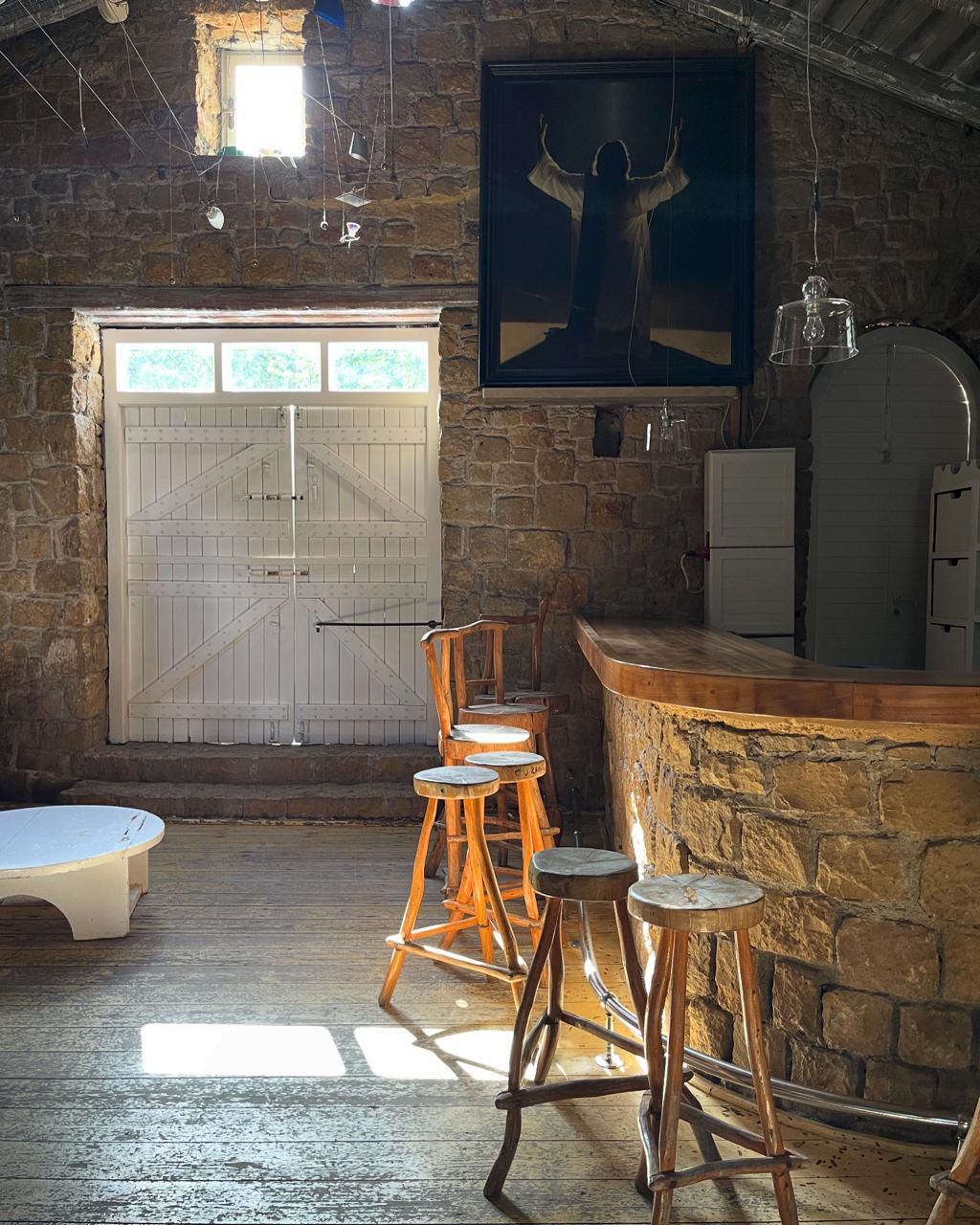 The interior of Alekos — wood, candles, low light