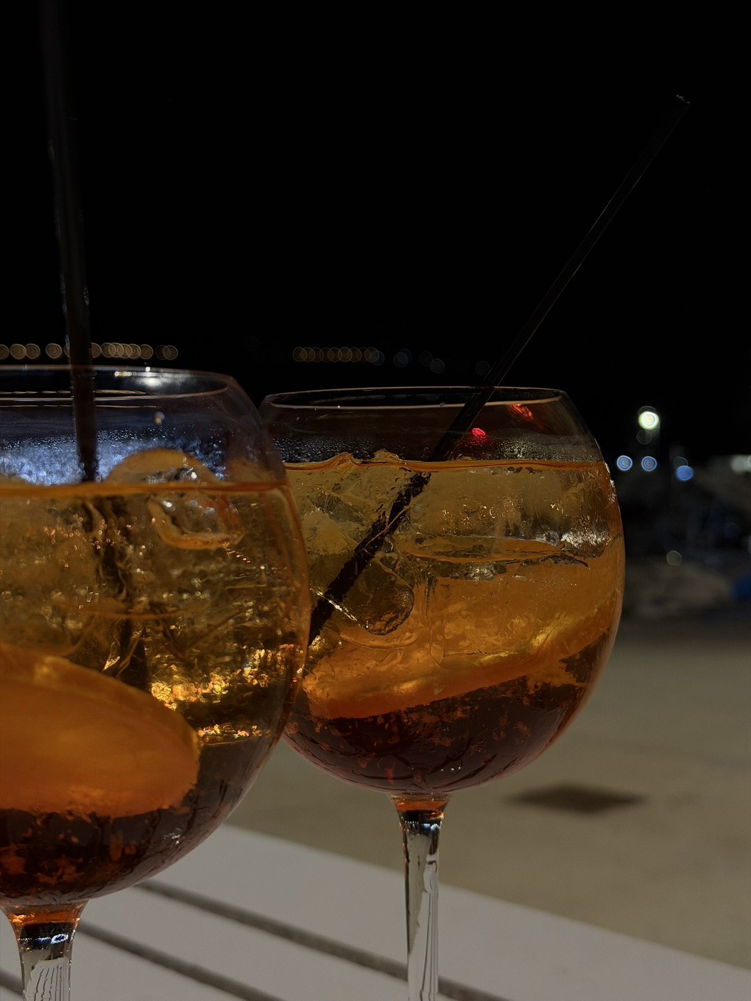Spritz cocktails by the sea at night